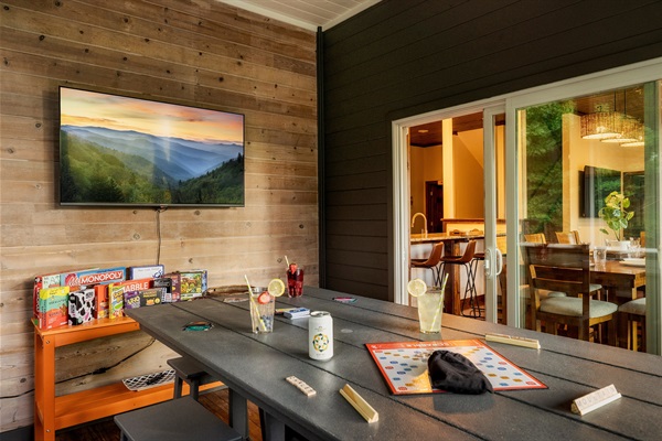 Enjoy dinner, drinks, or game night with mountain views on the screened porch.