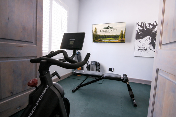 Enjoy the spin bike, weight bench with various weights and fitness equipment and plenty of gym flooring for stretching and workouts