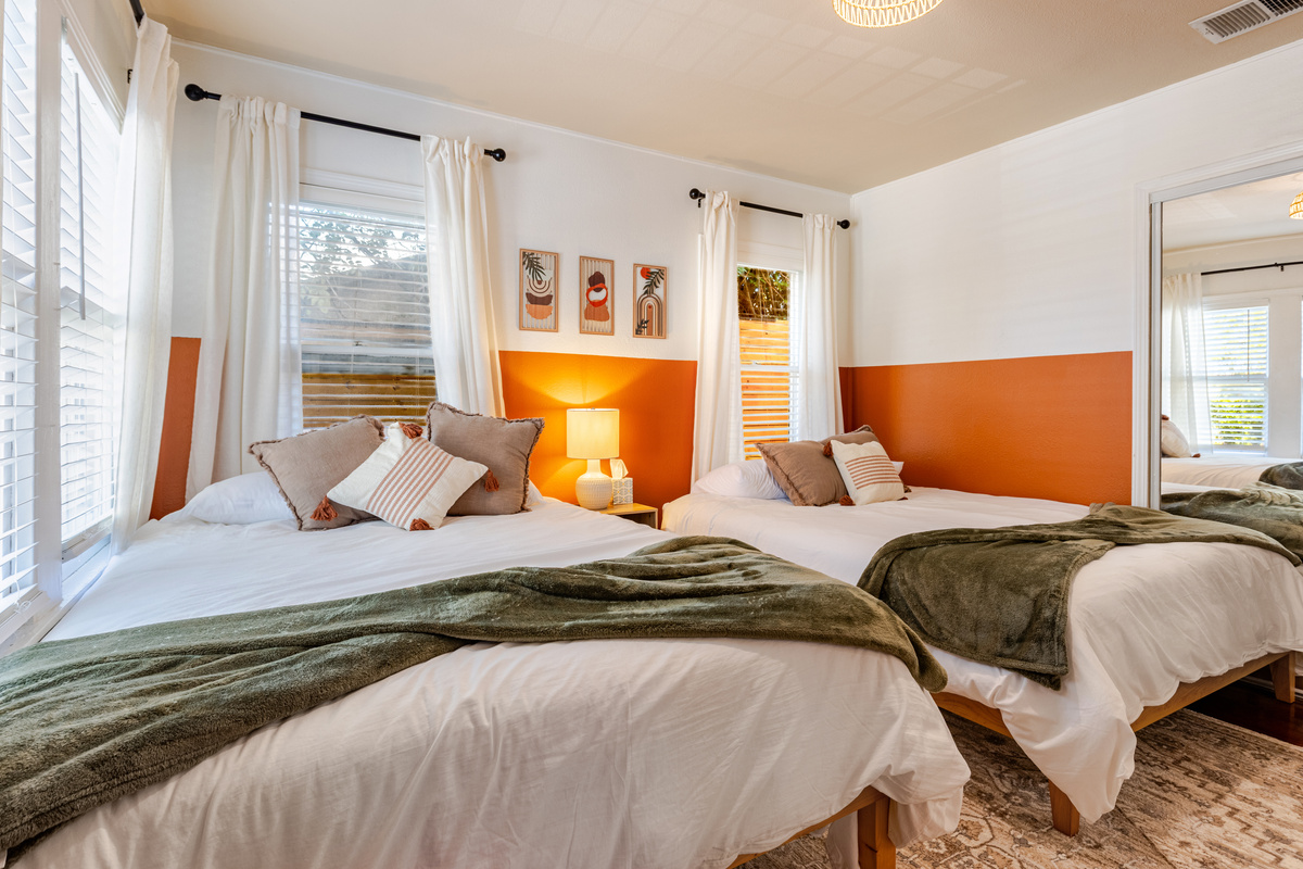 Bright and airy retreat with plush beds and playful decor for ultimate relaxation!