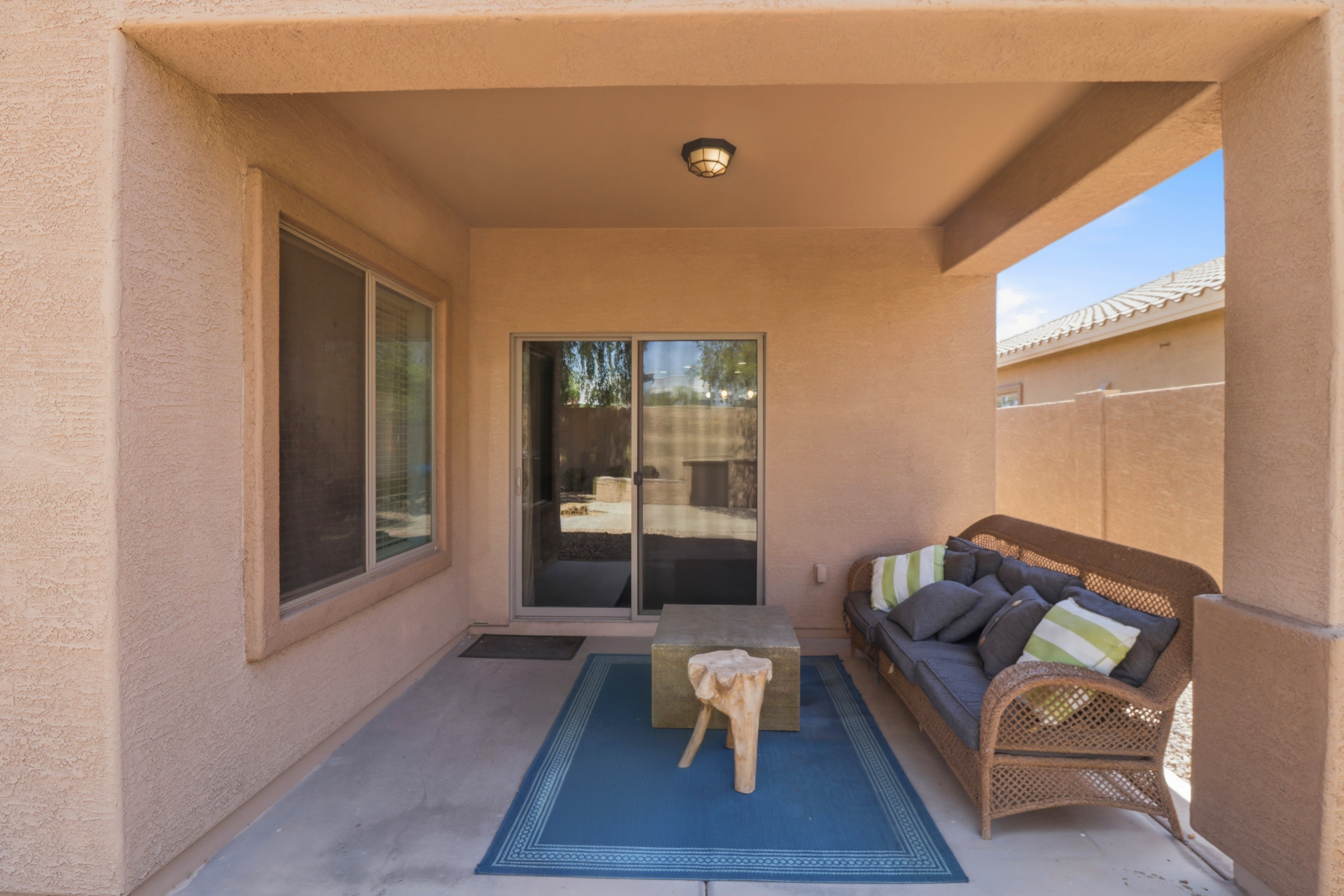 Covered patio with comfortable outdoor seating.