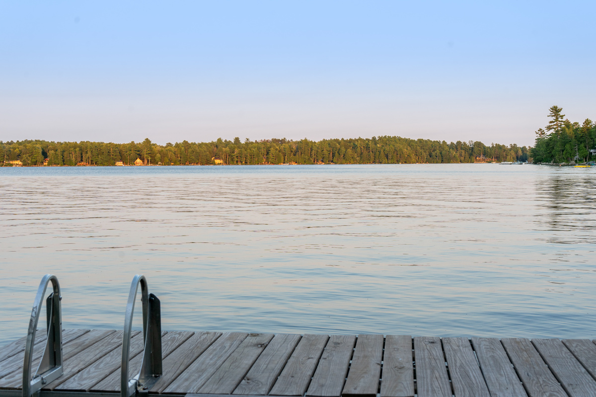 Stand at the edge of your private dock at Loonrise Point! Climb down the swim ladder into the clear water or sit and soak in wide-open views across Beech Hill Pond. Pure, serene Maine lakefront living in Otis, ME.