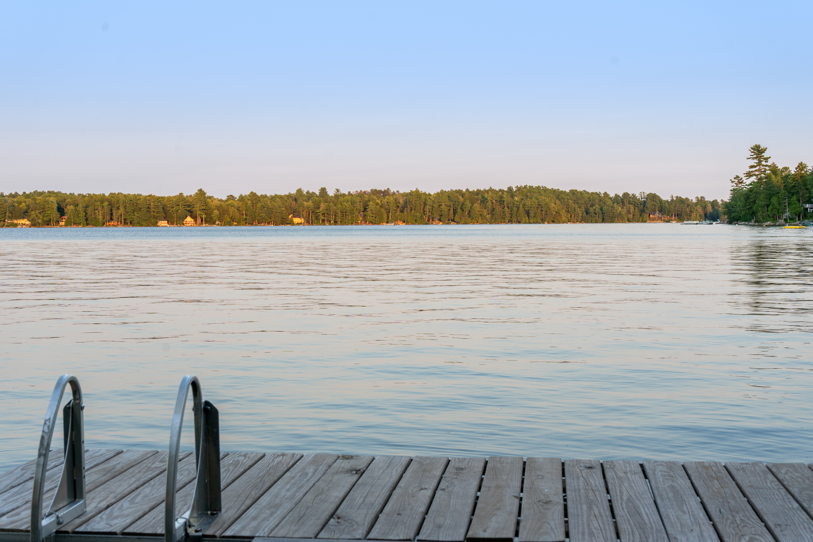 Stand at the edge of your private dock at Loonrise Point! Climb down the swim ladder into the clear water or sit and soak in wide-open views across Beech Hill Pond. Pure, serene Maine lakefront living in Otis, ME.