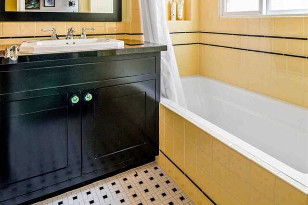 Full bathroom with tub/shower combo.