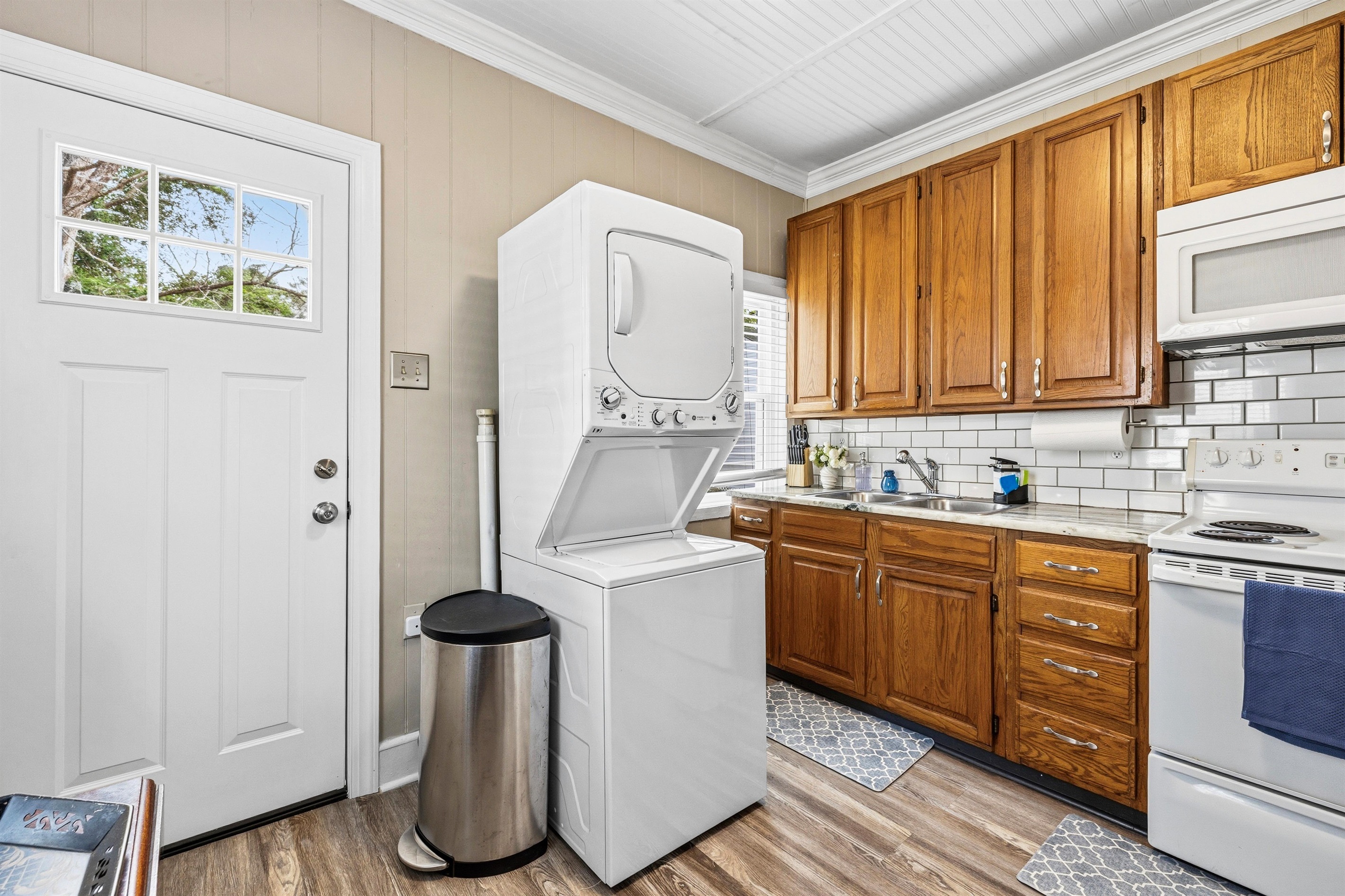 Within the kitchen is a stacked washer and dryer combination.