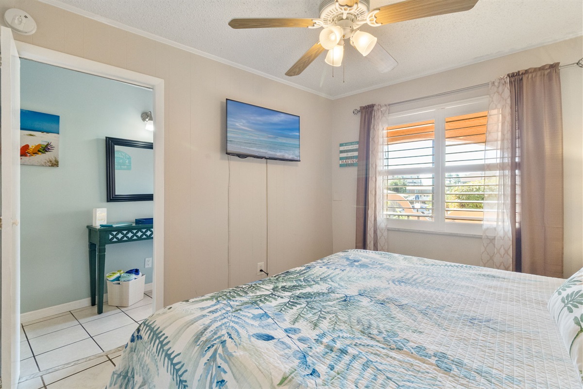 King size bed and free streaming TV in bedroom.