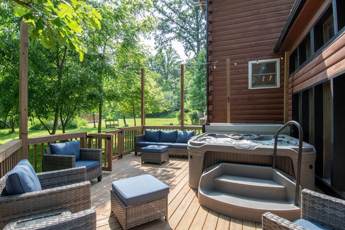 Seating for 7 people around the 7 person hot tub. Hot tub has convenient stairs and handrail for entry and exit.