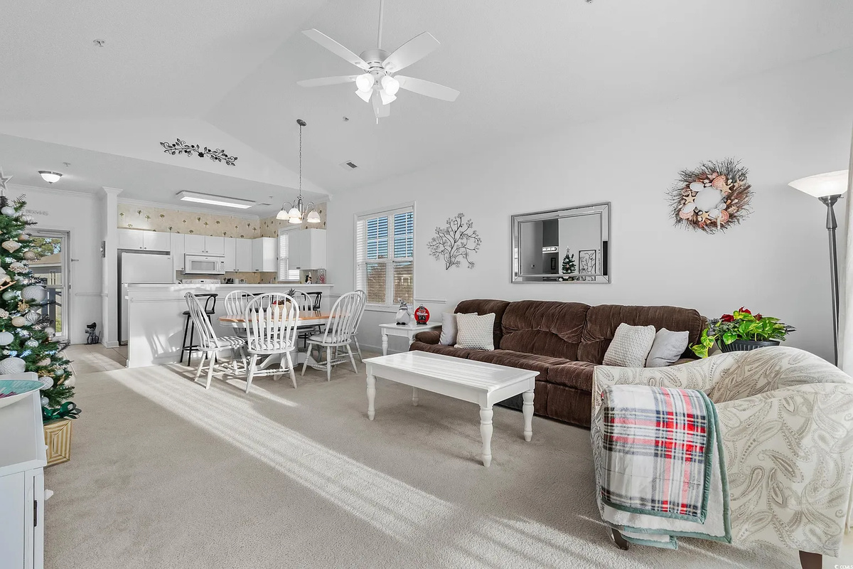 Cozy living room with large TV, sofa bed and balcony access