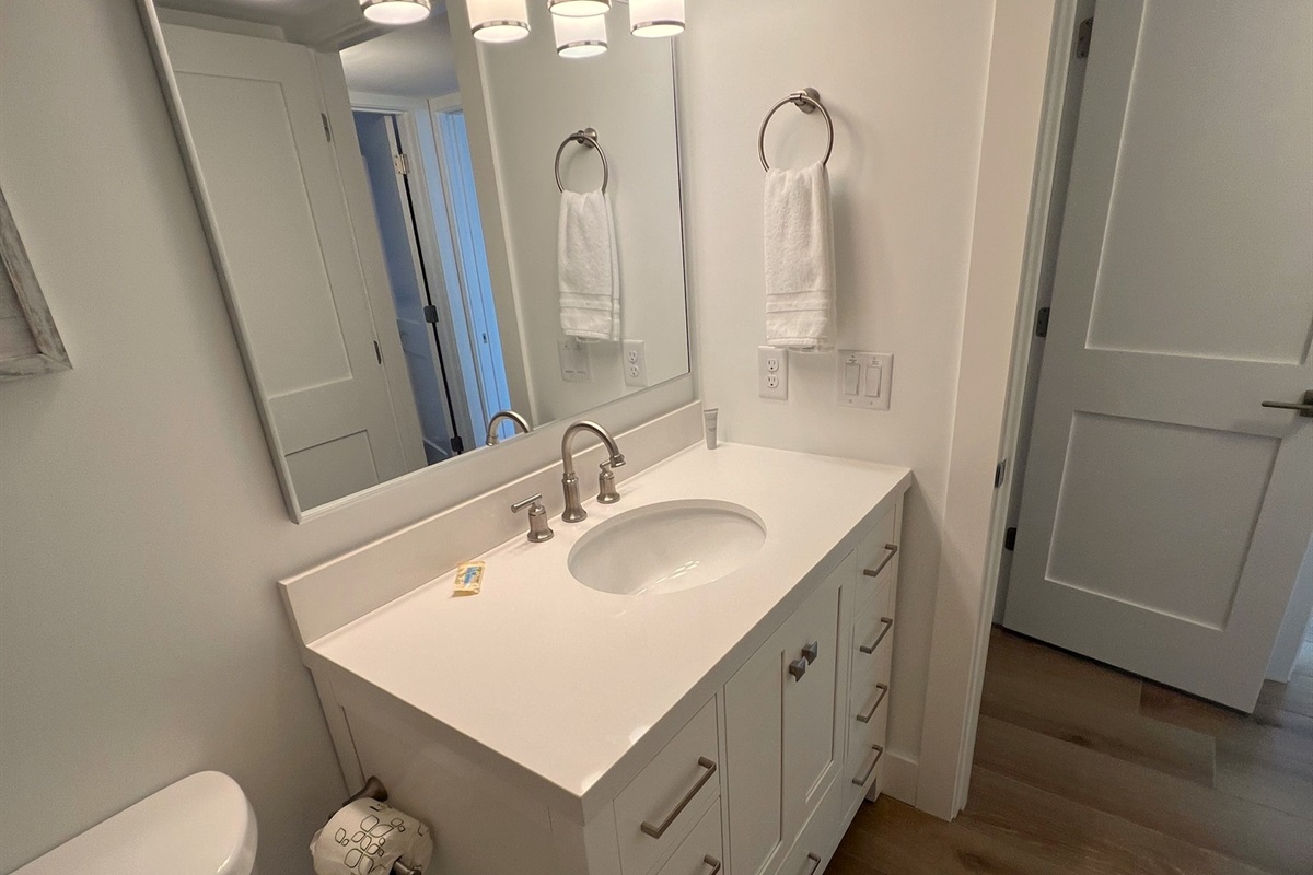 Guest bath to hallway with privacy door