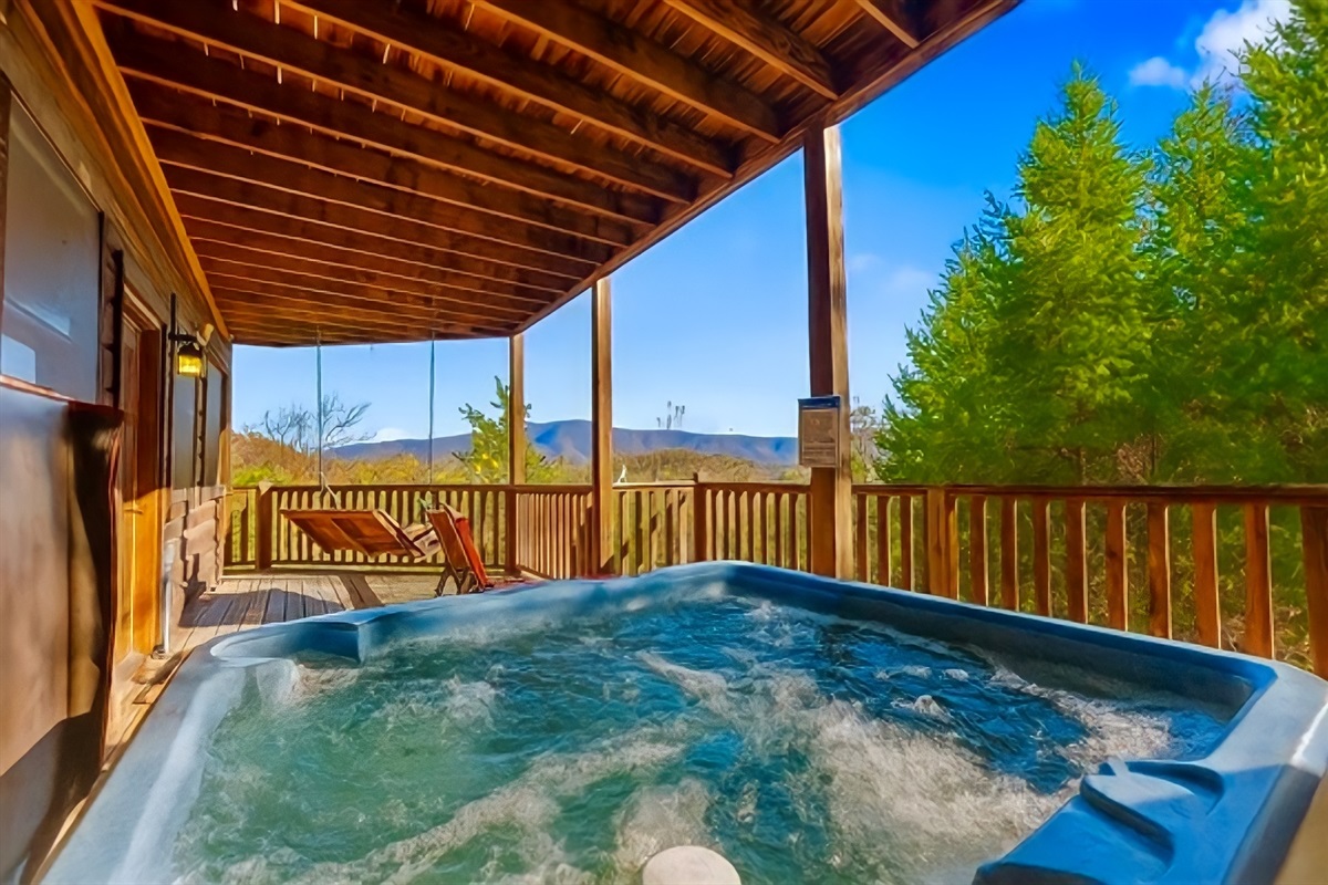 Unwind in the bubbling hot tub as you take in the peaceful mountain views, the perfect spot to relax, recharge, and breathe in the crisp cabin air.