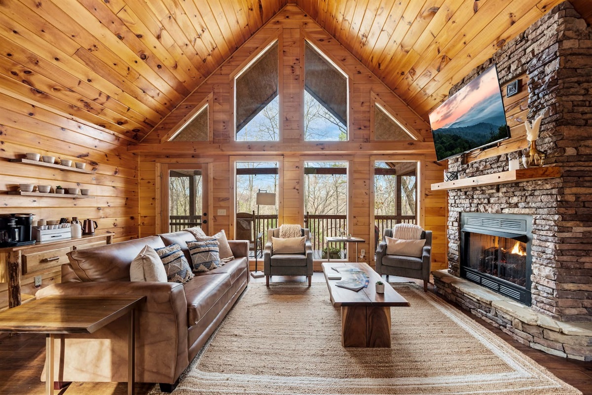 Living room with sleeper sofa, fireplace and beautiful deck.