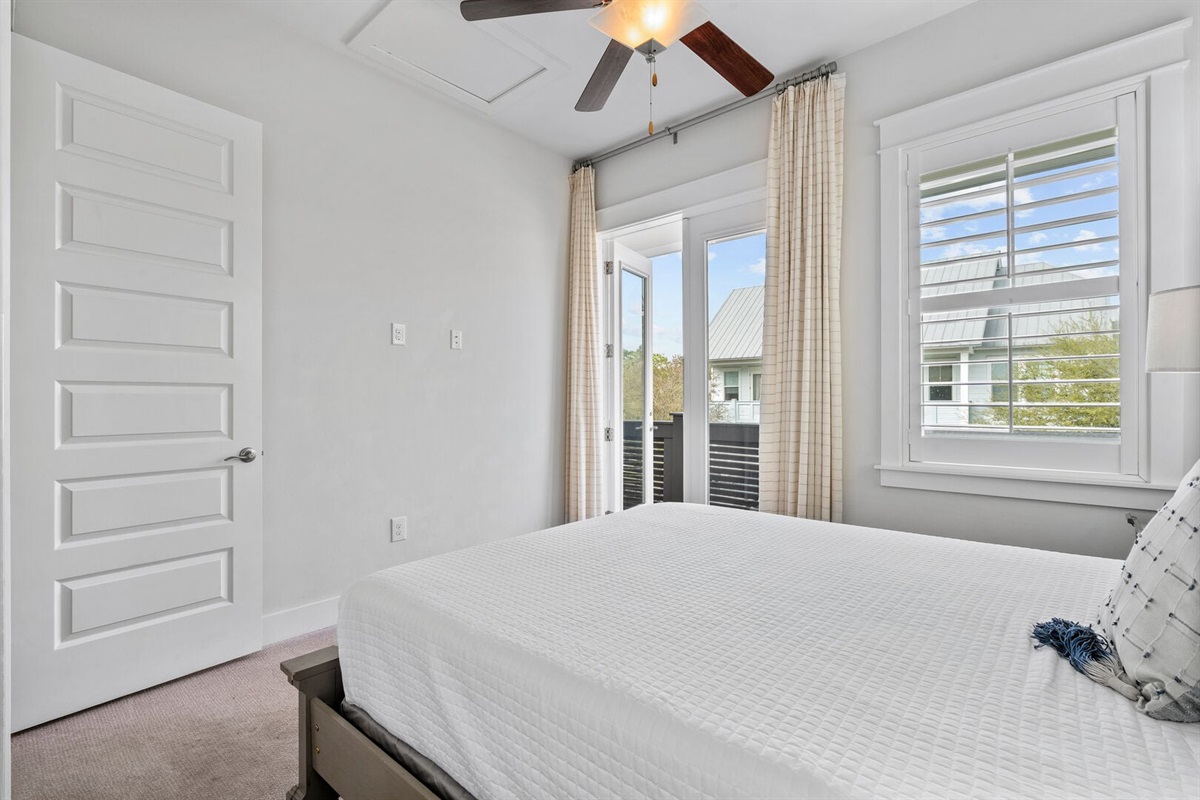 Primary suite with French doors to the balcony.