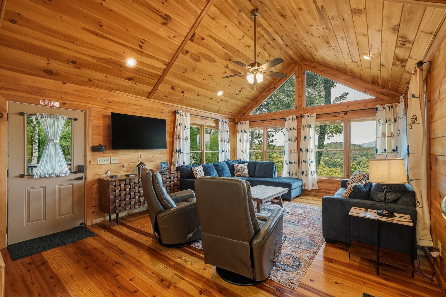 Living area with lots of seating, fire place and smart TV