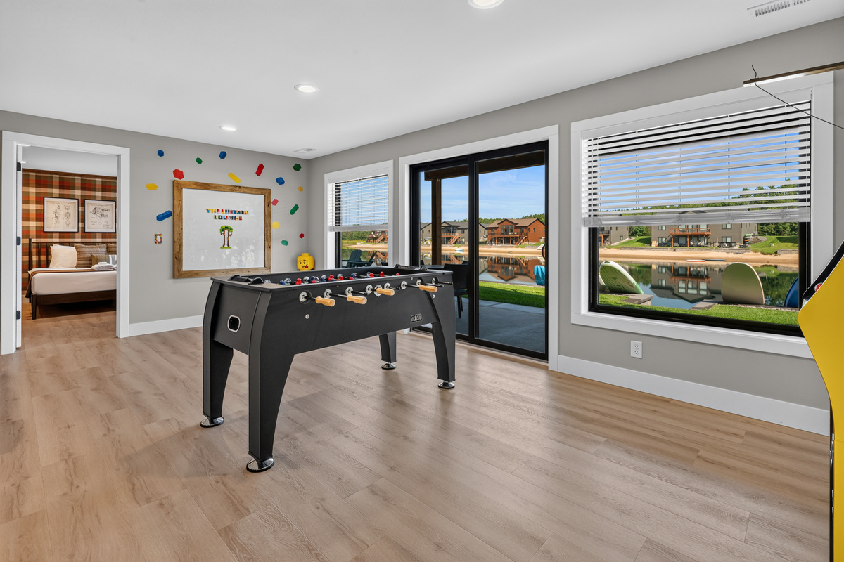 Lounge downstairs game area with foose ball, large lego wall and some arcade games