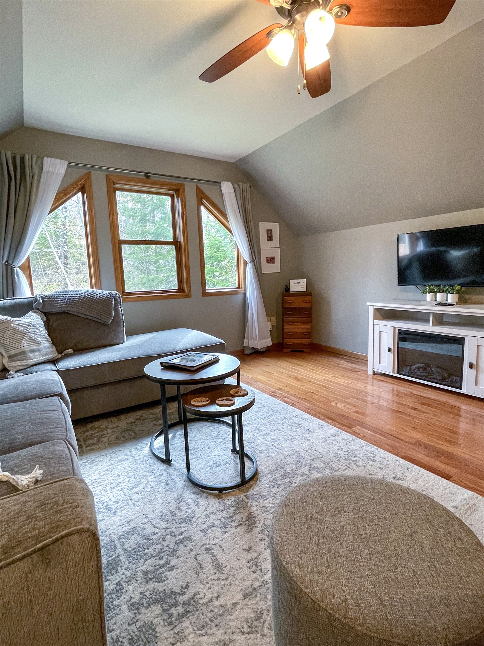 Upper level main living room with large windows electric fireplace open concept to kitchen. Queen sleeper sofa pull out memory foam mattress. 