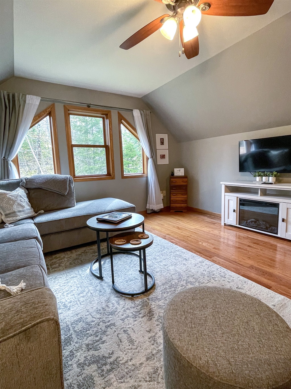 Upper level main living room with large windows electric fireplace open concept to kitchen. Queen sleeper sofa pull out memory foam mattress. 