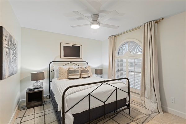 Bright and inviting guest bedroom with natural light and a comfortable sleeping space