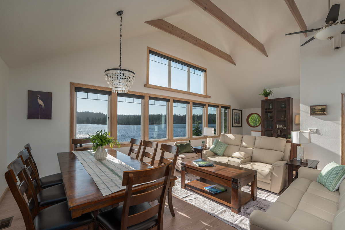 Open-concept living and dining spaces are bathed in natural sunlight, creating a bright, airy atmosphere with beautiful lake views throughout.