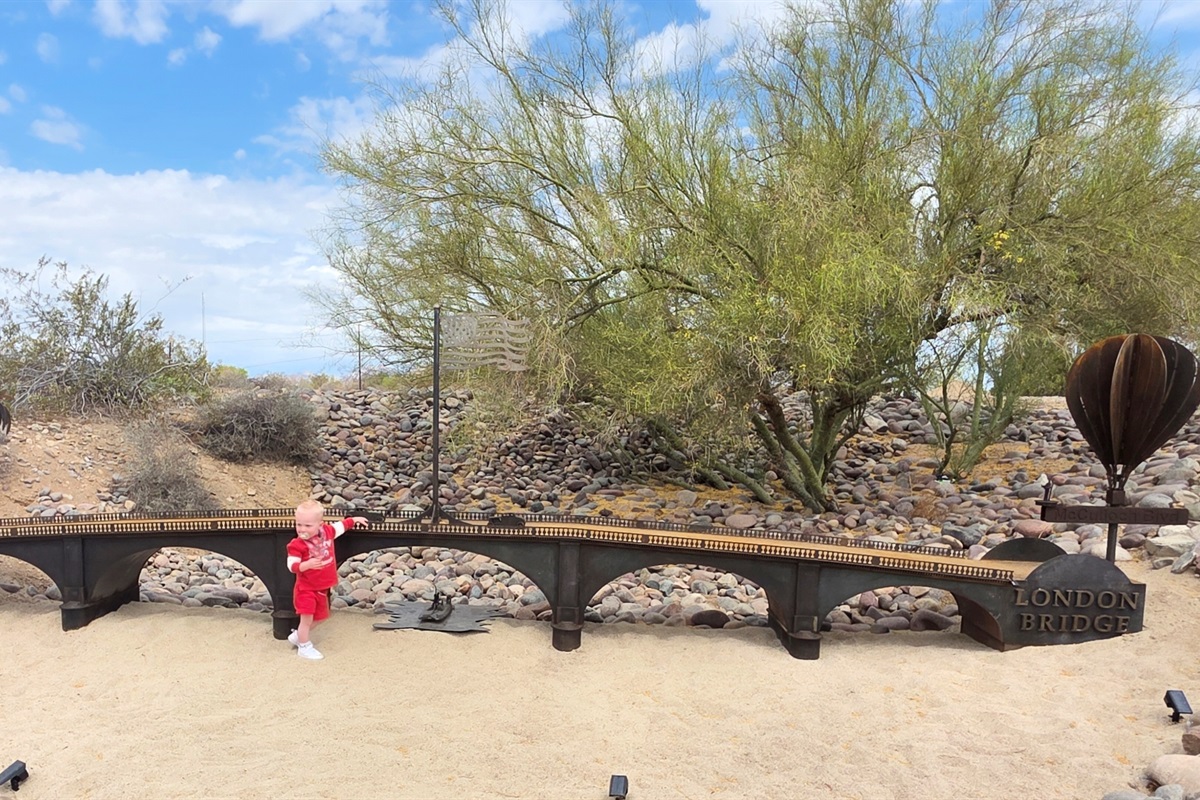 Our adorable grandson admiring the bridge replica on the Island that his Papa built. Be sure to check it out!