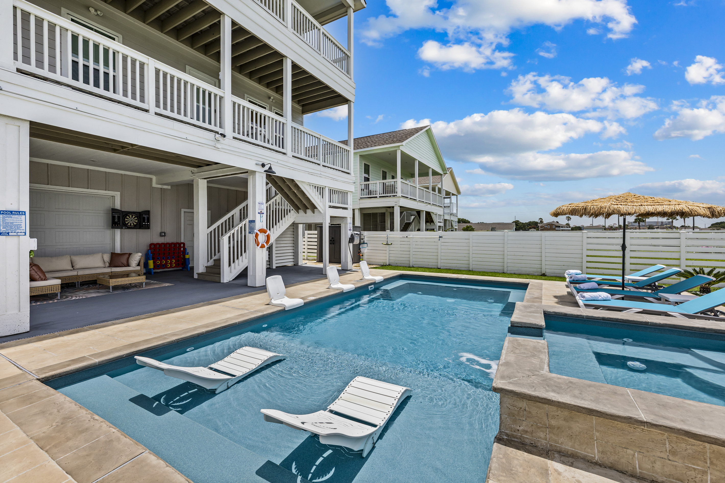 Spend the day soaking up the sun from the comfortable tanning loungers, cool off in the sparkling pool, relax in the shaded seating area, or challenge friends to a game of darts from the outdoor sectional. This backyard is designed for the ultimatevacation