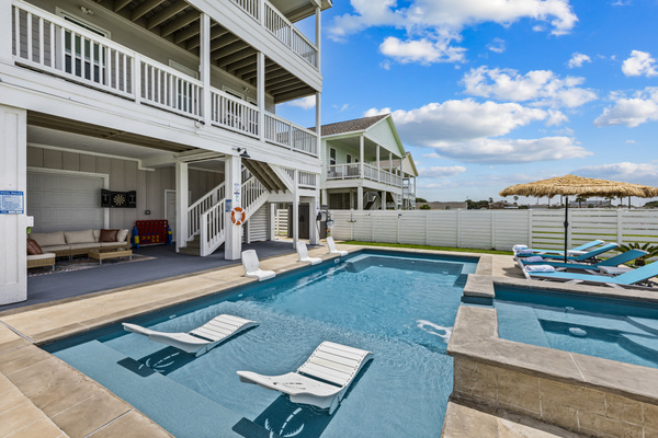 Spend the day soaking up the sun from the comfortable tanning loungers, cool off in the sparkling pool, relax in the shaded seating area, or challenge friends to a game of darts from the outdoor sectional. This backyard is designed for the ultimatevacation