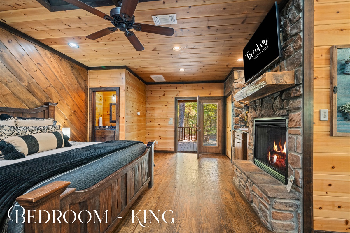 Romantic bedroom with fireplace and private sitting area.