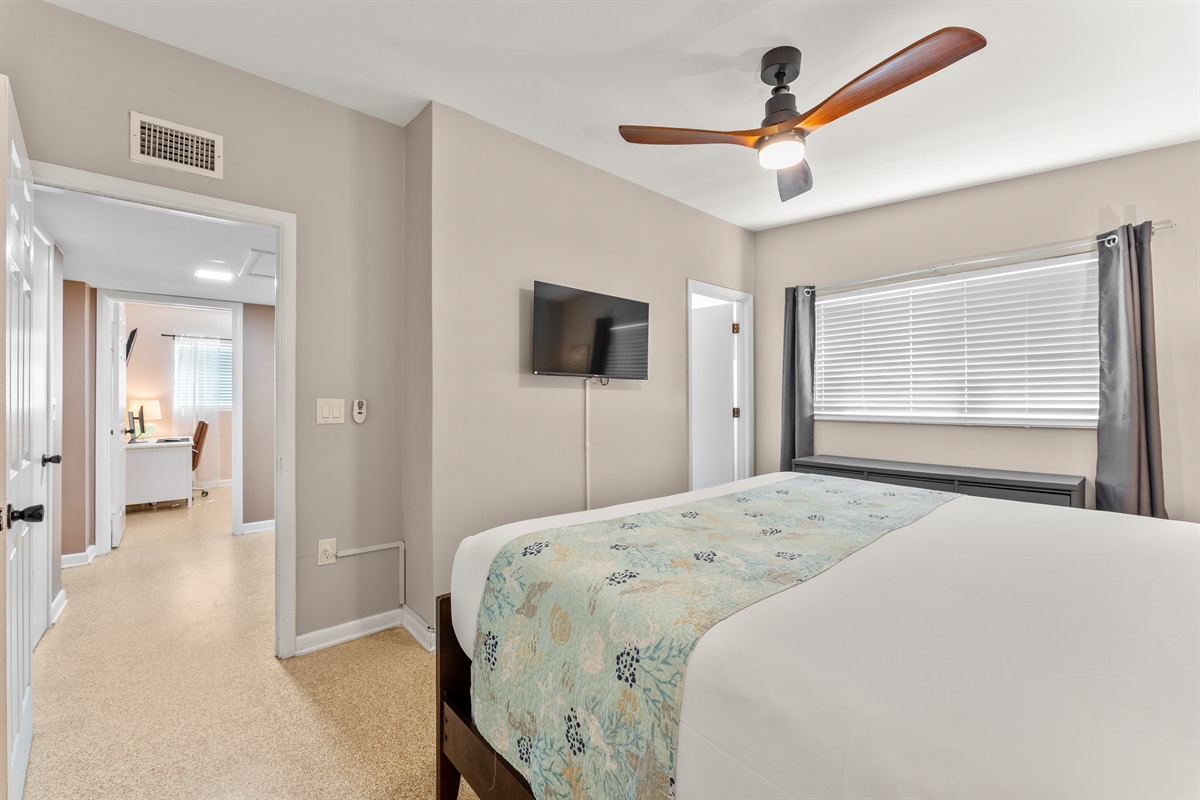 Primary bedroom with TV and en suite bathroom