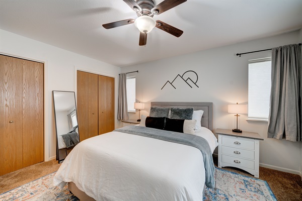 Bedroom has a comfortable queen bed with 100% cotton linens and cozy lighting for a relaxing ambiance.