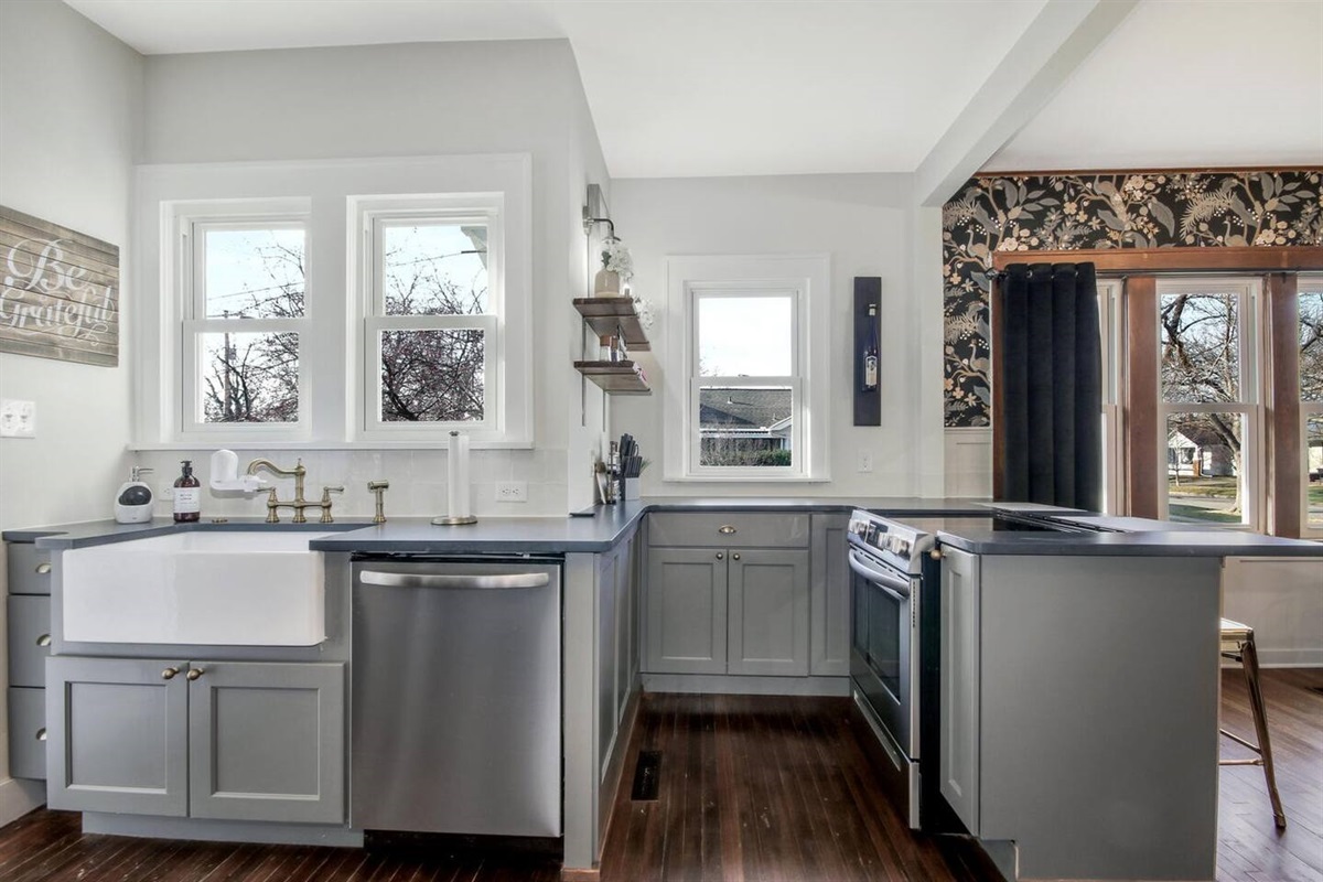 Sunny kitchen is fully stocked with everything needed to cook a meal.  Stove is electric.