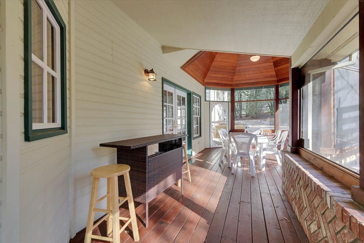 Sunroom with table seating, bar counter, and a peaceful spot to enjoy the view.
