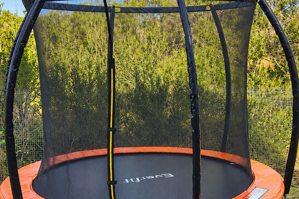 Kids can enjoy some extra outdoor fun at Carlenes Getaway with this netted trampoline in the garden.