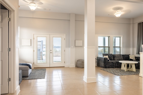 Playroom/Bonus Space with sleeper sofas and 65 inch Roku TV. Direct access to dock and Lagoon views.