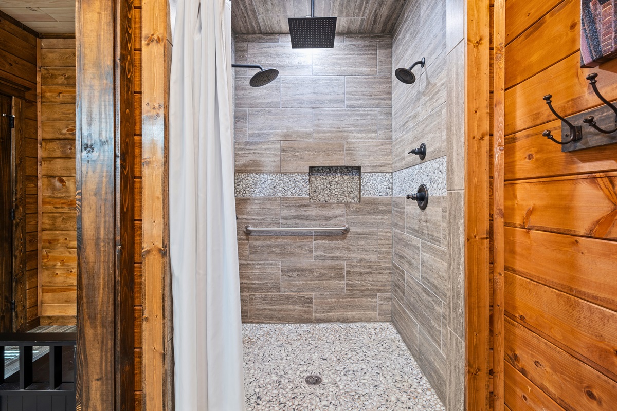 A beautifully finished walk-in shower highlights modern tile work and a clean design, offering a refreshing and spa-like experience during your stay.
