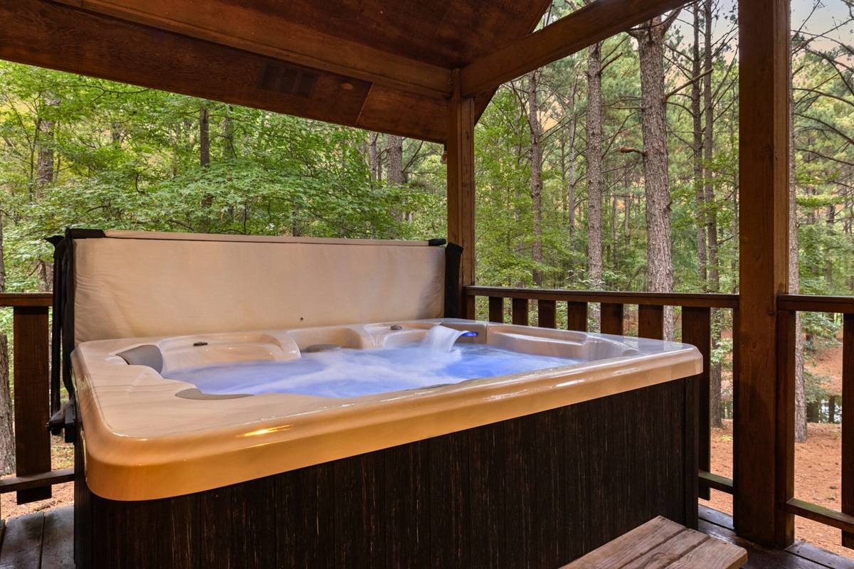 Soak under the trees in your private hot tub escape