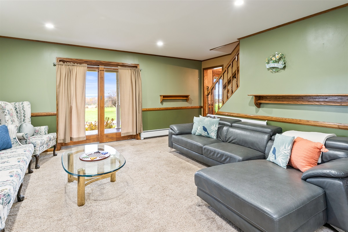 Bright and inviting lounge with ample seating and backyard views — comfort meets Finger Lakes charm.