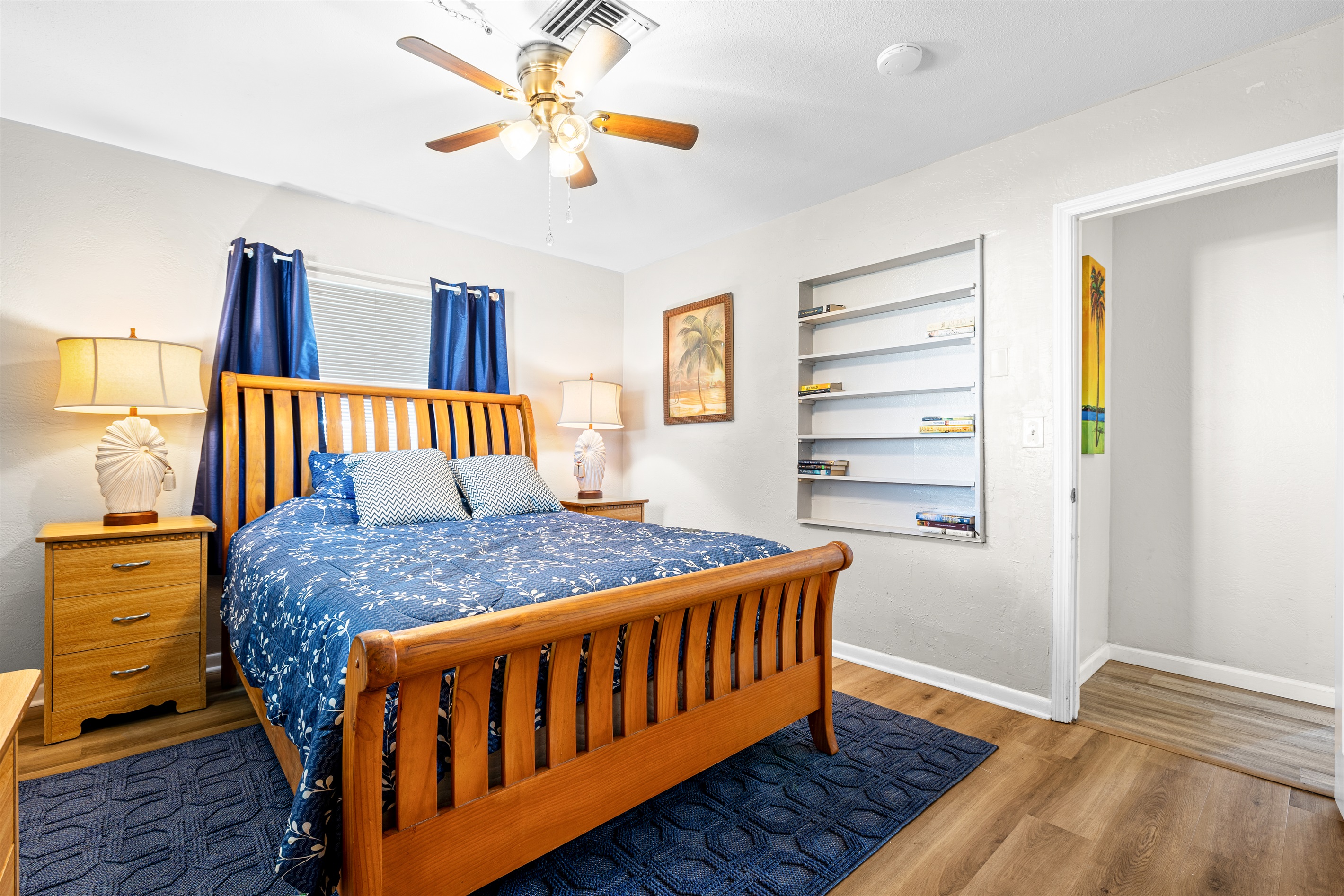 No Wake Queen Bedroom with Roku TV, a bookshelf, 2 nightstands, a dresser and two closet areas.