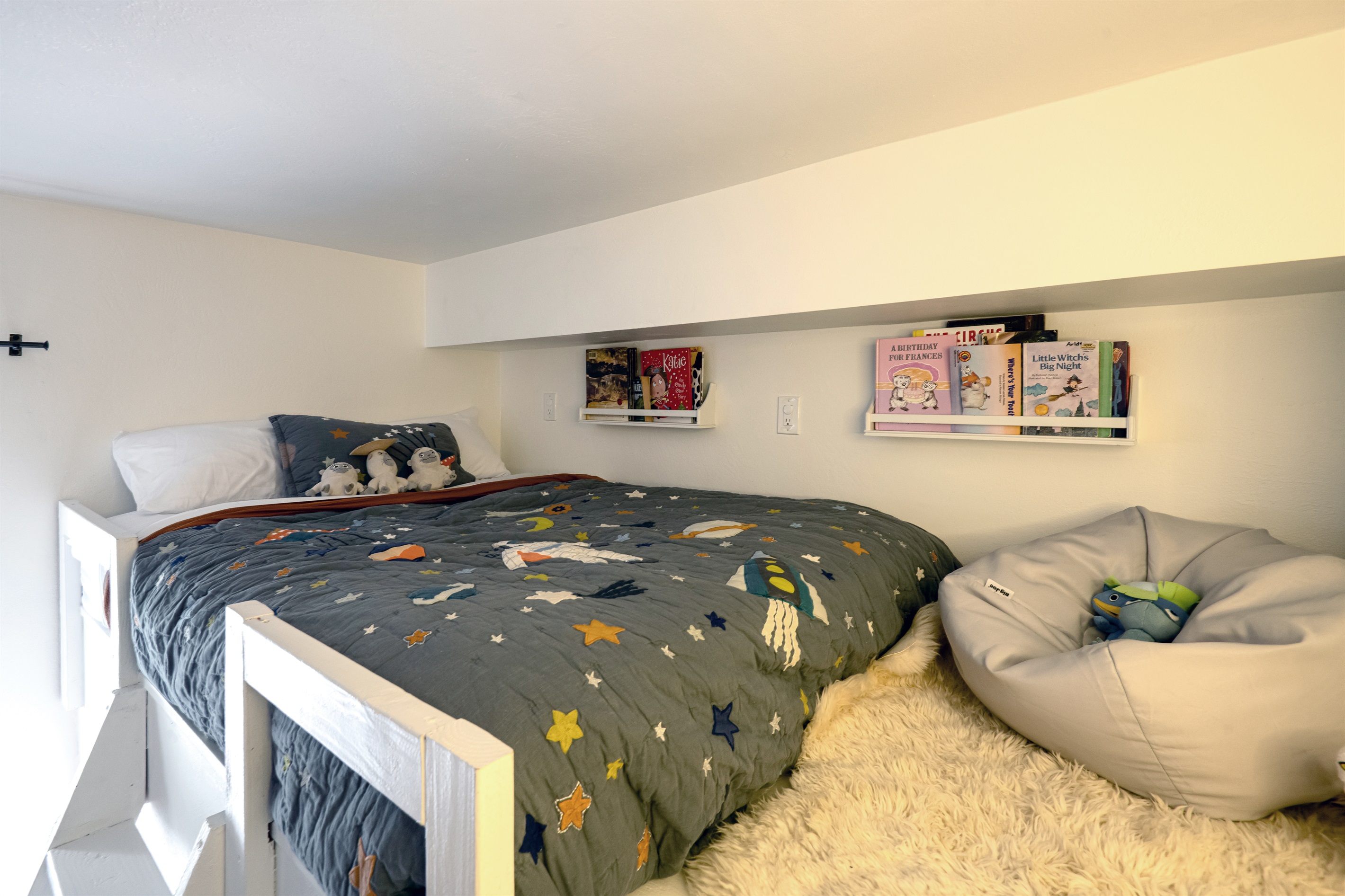 Cozy loft sleeping space with playful decor—perfect for kids or a fun, tucked-away retreat.