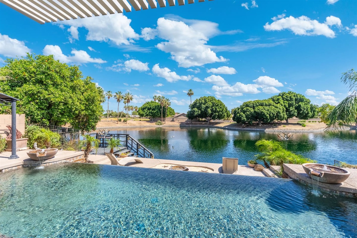 Standing at the pool's edge, the lake stretches out in front of you and the sky opens wide — it's the kind of view that makes you feel like you have the whole place to yourself.