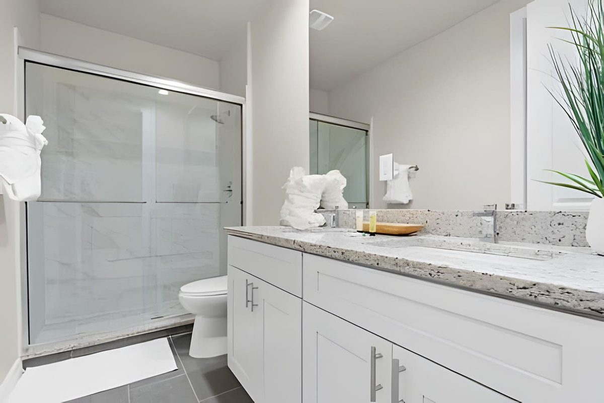 Enjoy a spacious, well-lit bathroom with sleek, contemporary design.