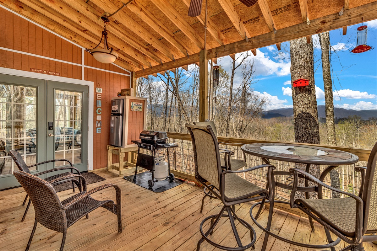 Deck with seating, Propane Grill, and mini fridge.