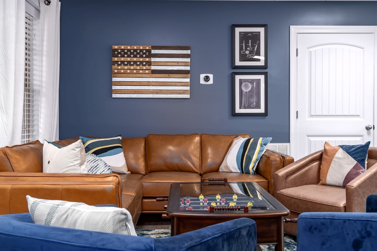 Downstairs entertainment room with lots of fun board and card games, shuffleboard table, 75" large screen smart TV,  and gathering spot 