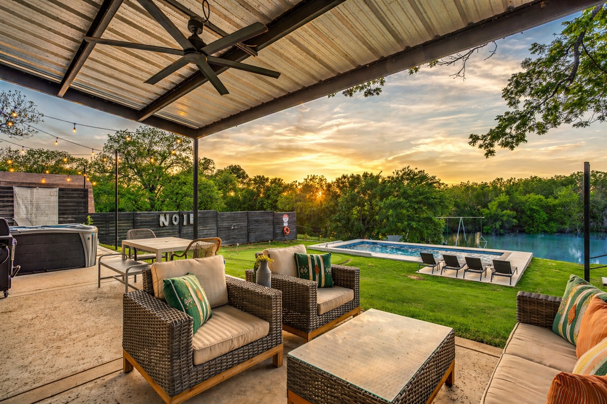 Covered outdoor living, private pool, putting green, and lakefront views at The Noir, a luxury vacation rental on Lake Granbury, Texas.
