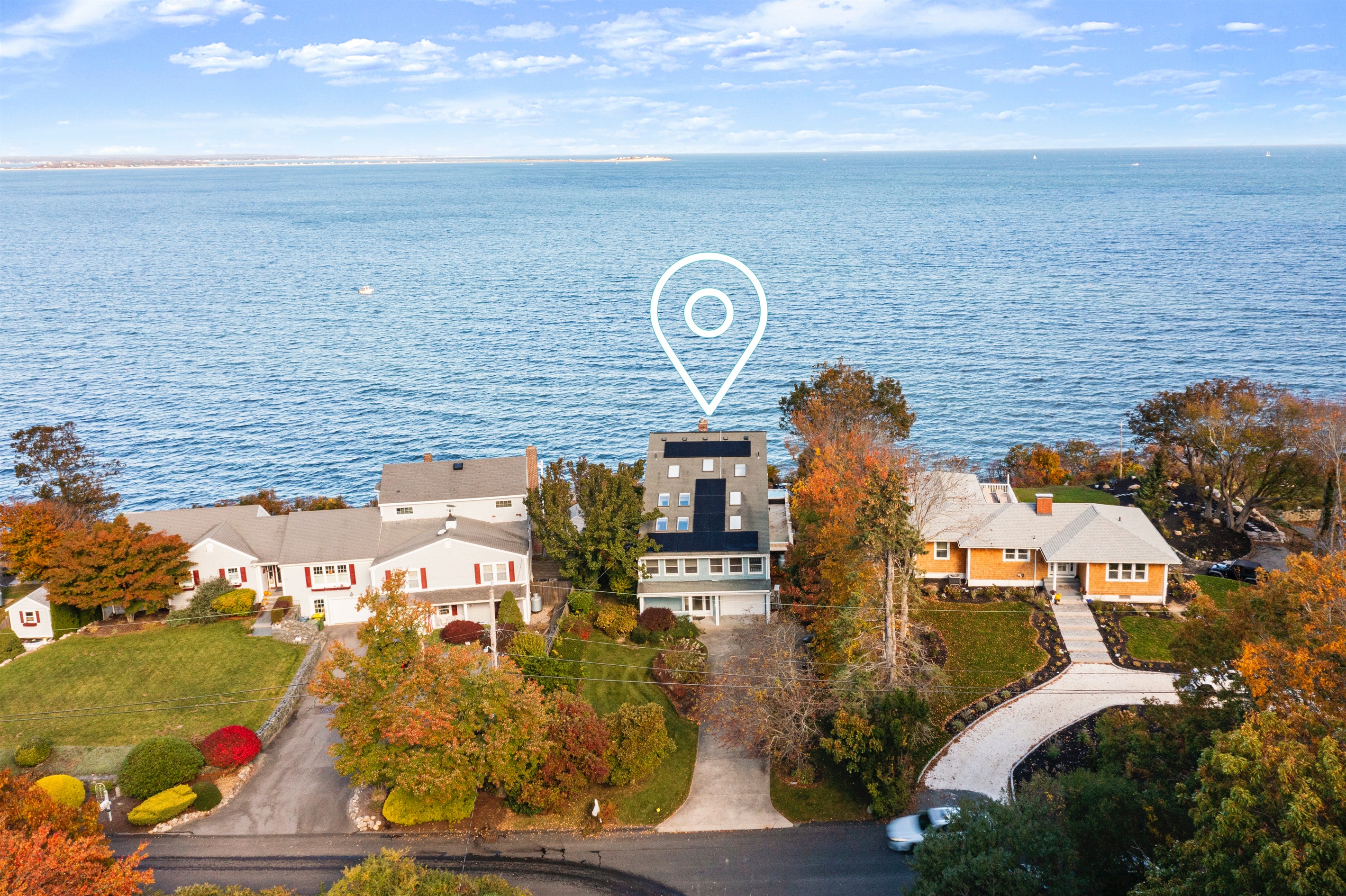 Bird’s-eye view showcasing the house and sparkling coastal waters