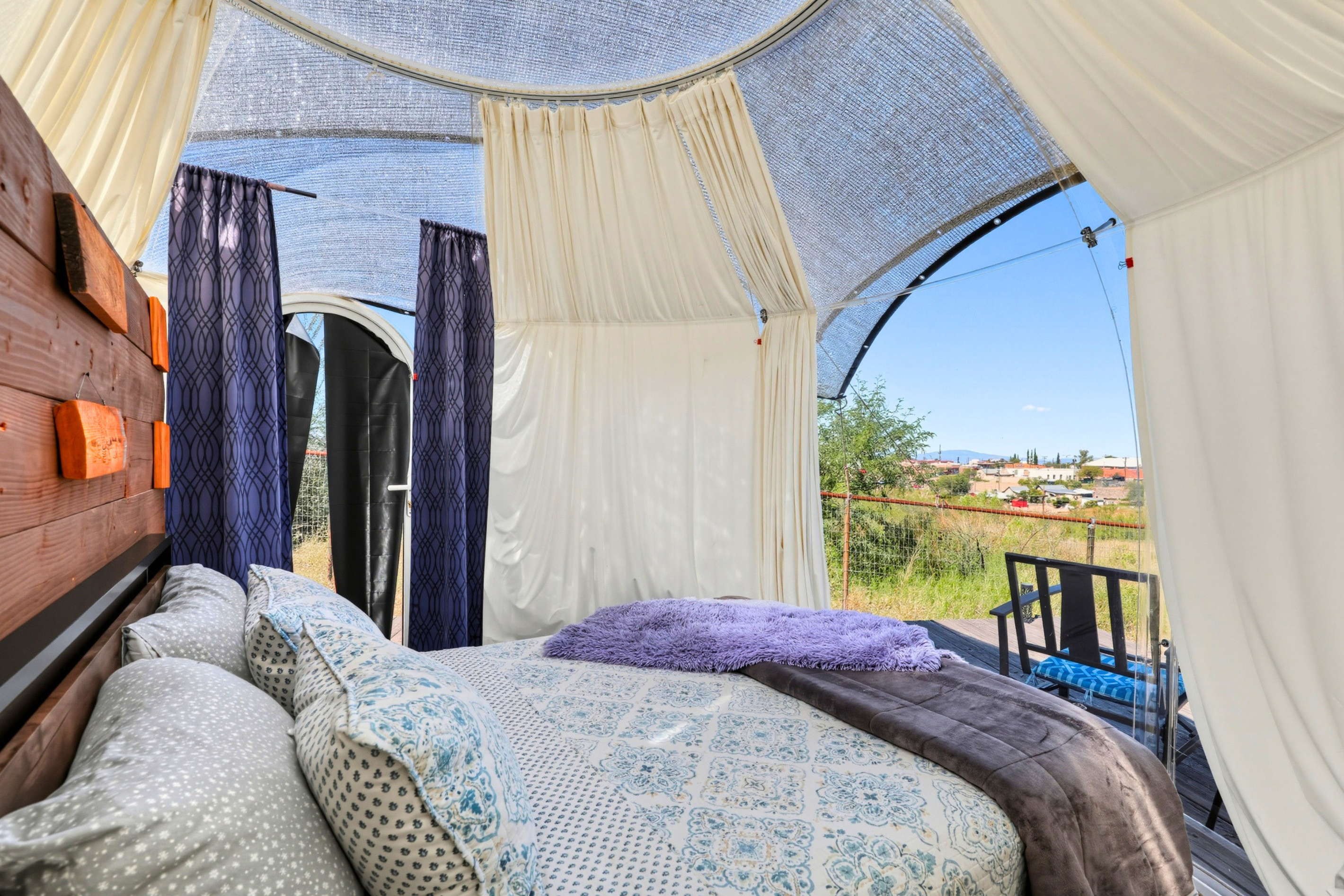 Open the curtains and enjoy the inviting queen bed inside your dome retreat
