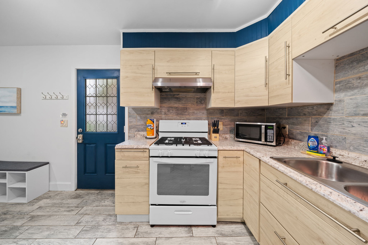 Full kitchen with gas stove, oven, and plenty of cabinet and counter space