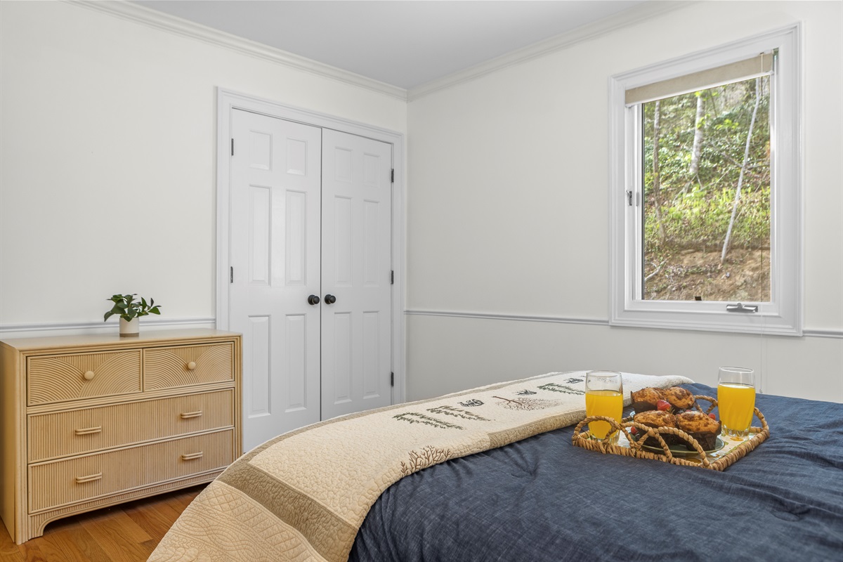 Queen Bedroom 2: Bright space with inviting decor, perfect for restful nights and breakfast in bed!