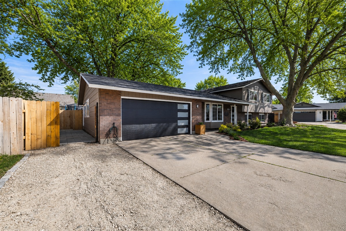 View of the front of the house.  Your parking is left of the driveway and private entrance is through the gate on the left side of the house.
