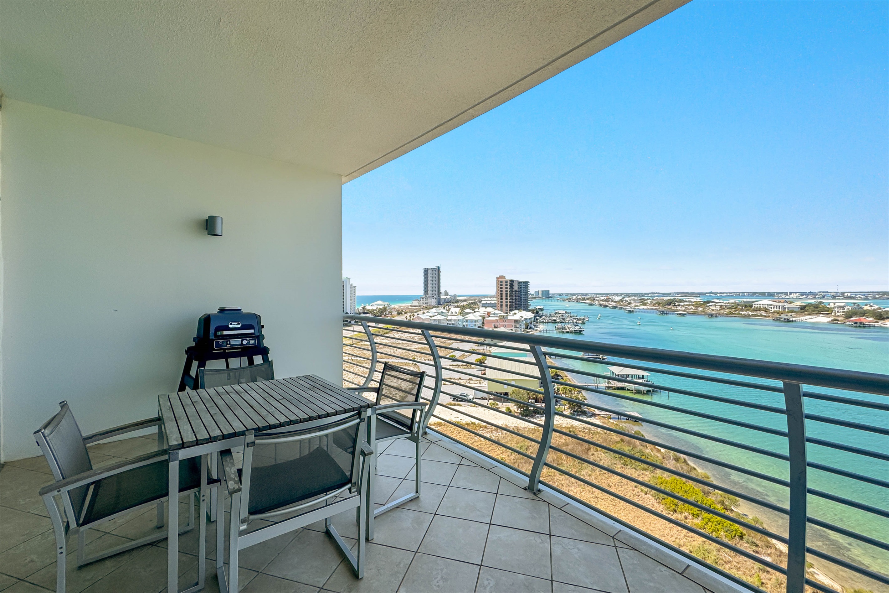A stunning balcony view offering a glimpse of the serene waterfront. A perfect spot to relax and enjoy the scenery.