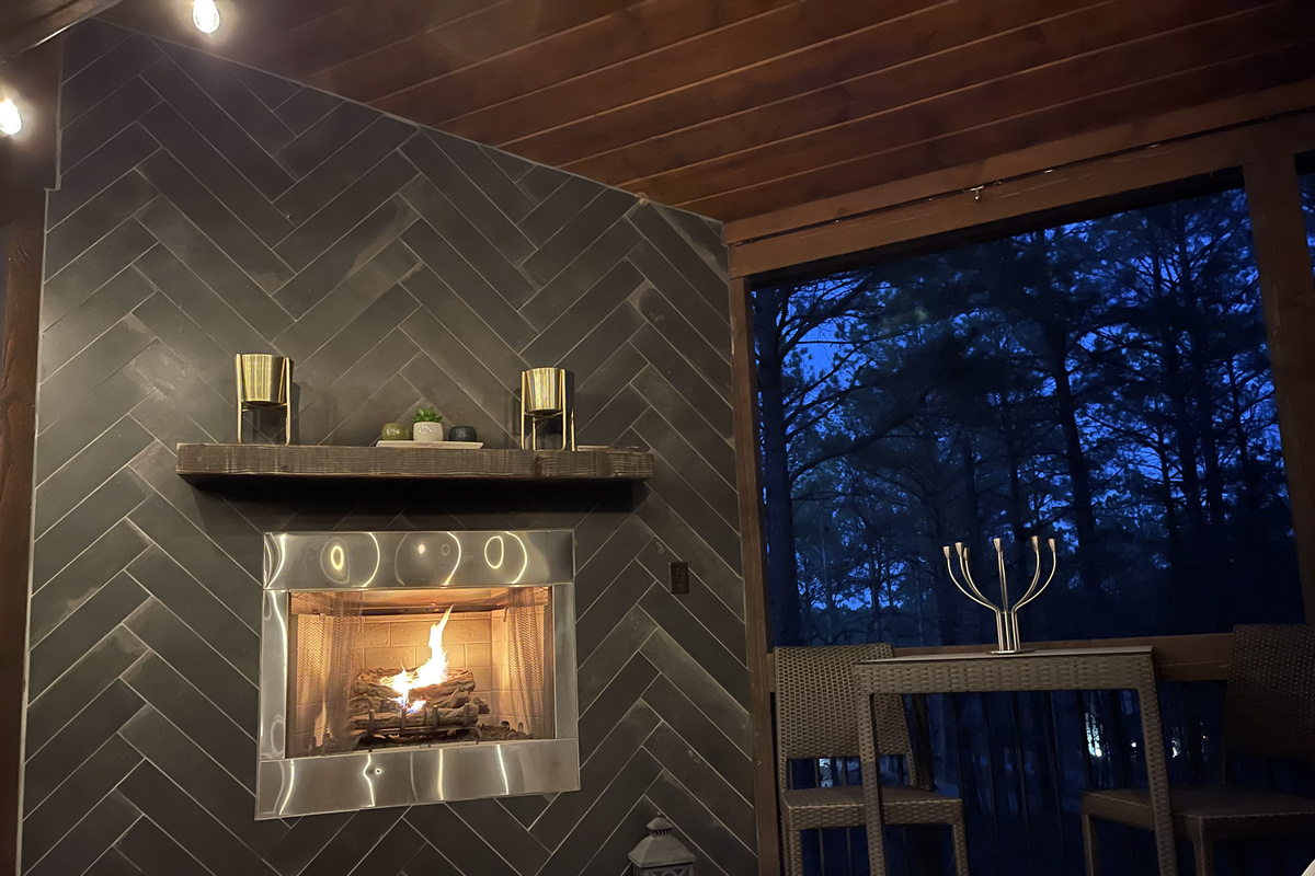 Evening relaxation by the seasonal outdoor fireplace provides added ambiance to relax on the deck.