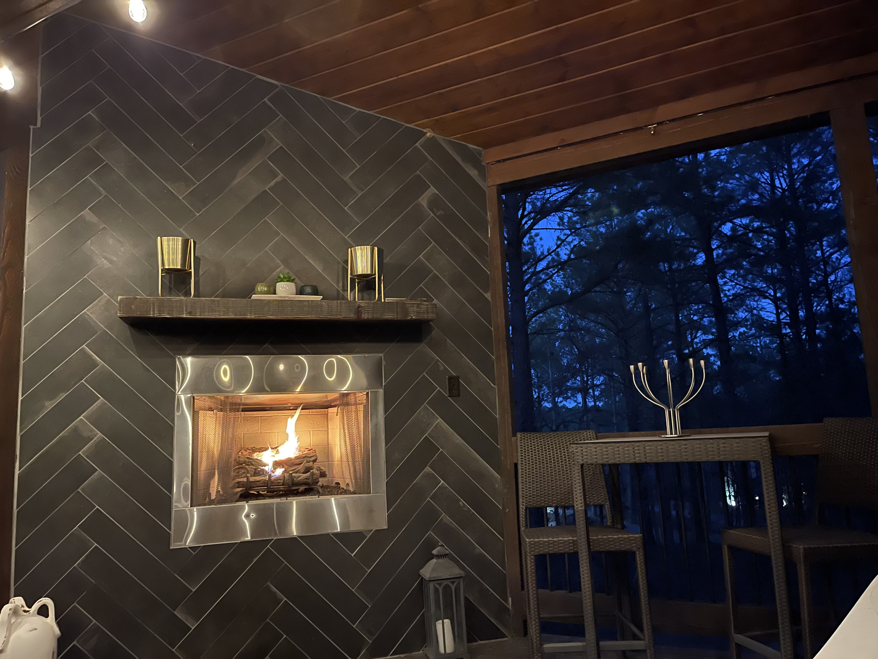 Evening relaxation by the seasonal outdoor fireplace provides added ambiance to relax on the deck.
