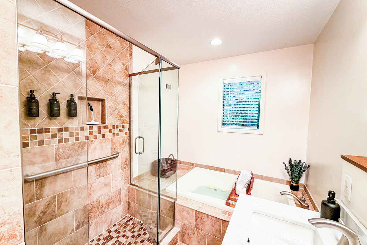 Indulge in a spa-like retreat within the master en-suite bathroom, featuring a beautifully tiled shower and a relaxing whirlpool tub for ultimate rejuvenation.